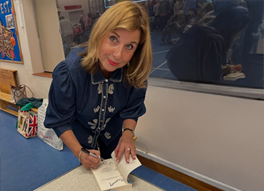 Nicola signing books